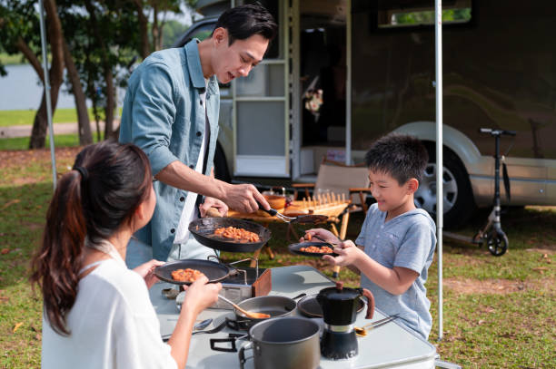 istock Asian family preparing breakfast meal beside the camper van 2171915621
