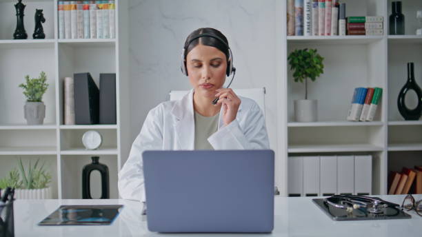 istock Physician headset offering consultation modern office polyclinic closeup. 2171921808