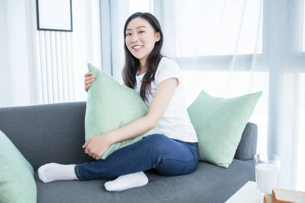 istock Young woman with soft pillow at home 2171922866