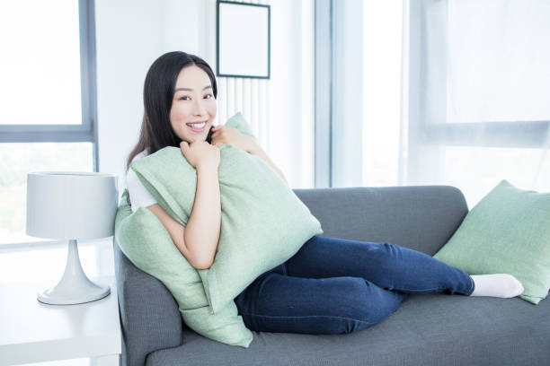 istock Young woman with soft pillow at home 2171922962