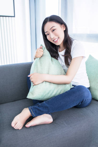 istock Young woman with soft pillow at home 2171923254