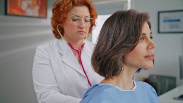 istock Therapist checking woman lungs with stethoscope in clinic office closeup. 2171925549