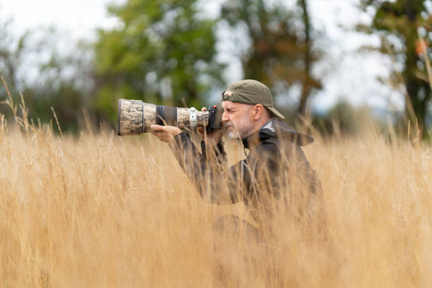 istock wildlife photographer during work in dry grassland 2171927516