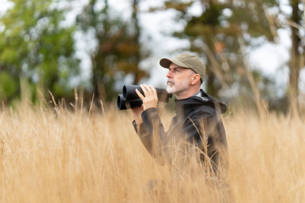 istock park ranger watching in dry grassland 2171927545
