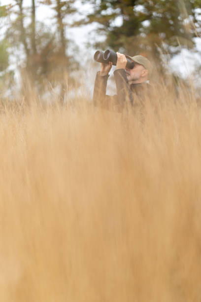 istock birdwatching in dry grassland with high grass 2171927568