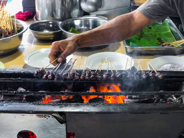 istock Grilled Satay Skewers Over Charcoal With Hands Preparing 2171928026