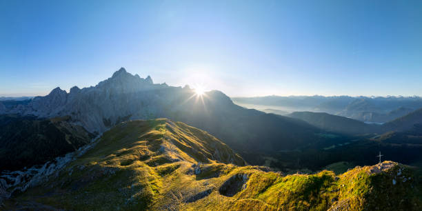 Aerial view in the Dachstein mountains with a view to Gosaukamm at sunrise from mount Rötelstein