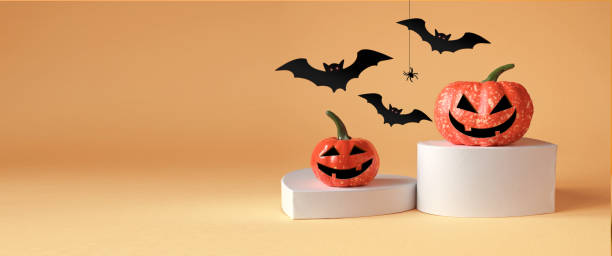 istock Halloween decorations with pumpkin on podium, spider and bat on orange background. Halloween concept. 2171933415