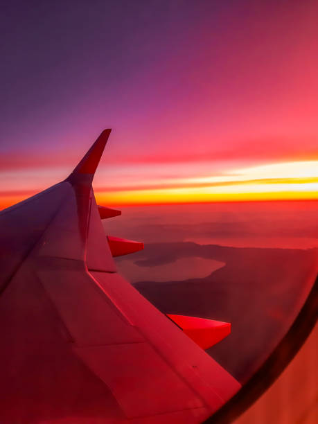 Colourful sky and aeroplane wing overlloking Europe