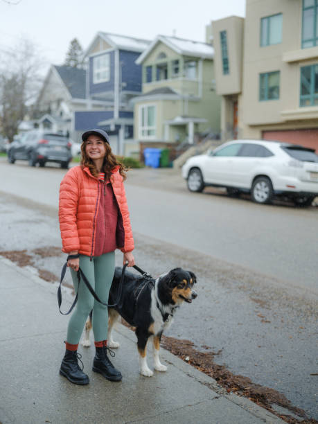 istock Woman walking her active dog in suburbs  in springtime 2171952758