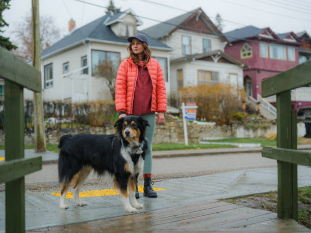 istock Woman walking her active dog in suburbs  in springtime 2171952802