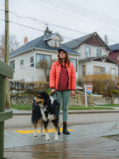 istock Woman walking her active dog in suburbs  in springtime 2171952875