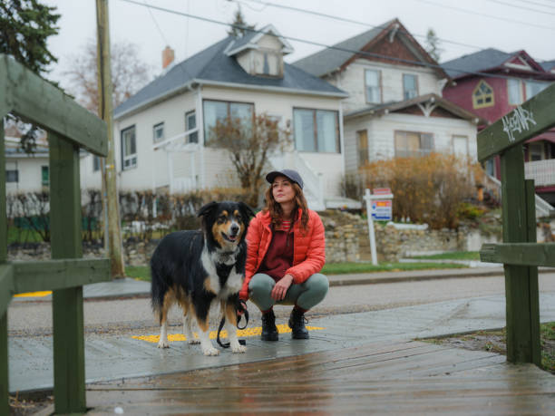 Woman walking with the dog in the suburbs
