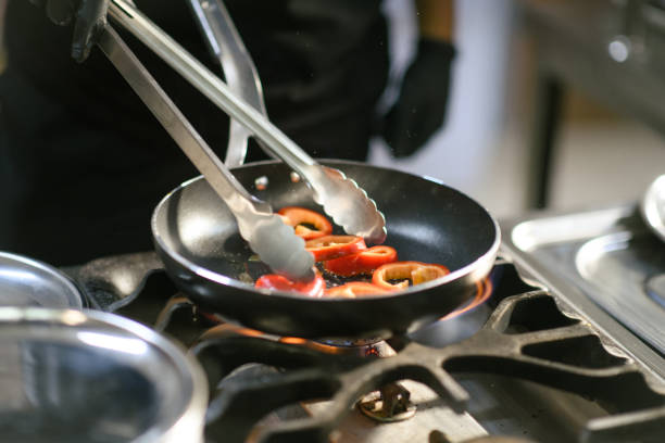 istock Chef grilling peppers in a pan in a hotel kitchen 2171958169