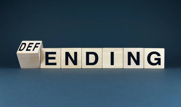 istock A conceptual image featuring wooden blocks spelling DEFENDING and ENDING. 2171963807