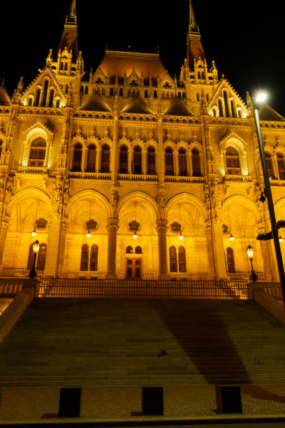 The illuminated Hungarian Parliament Building reflects beautifully in the Danube River, showcasing its stunning neo-Gothic architecture.