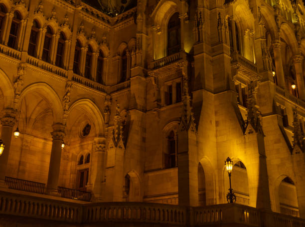 The illuminated Hungarian Parliament Building reflects beautifully in the Danube River, showcasing its stunning neo-Gothic architecture.