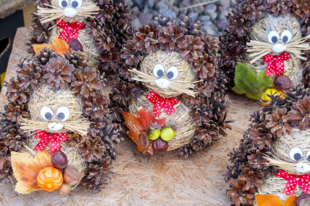 istock .A beautiful hedgehog with flowers is made from straw and cones 2171974347
