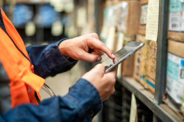 istock Close-up of an operator's hands working with a digital tablet in the hardware store. 2171976171
