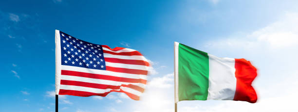 istock USA and Italy flags against blue sky background 2171977742