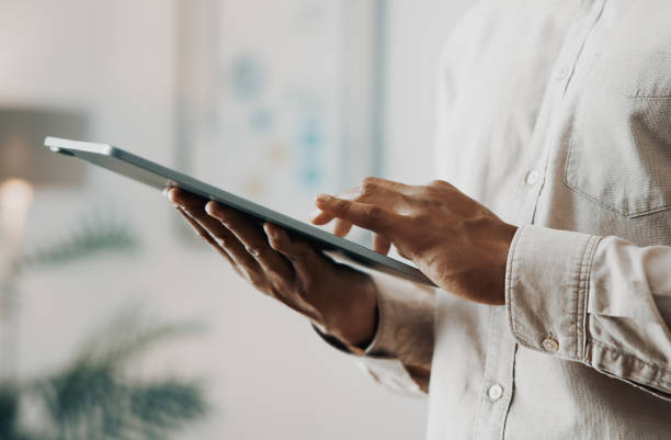 istock Close-up of a Businessman Typing on Digital Tablet in Office Setting 2171977821