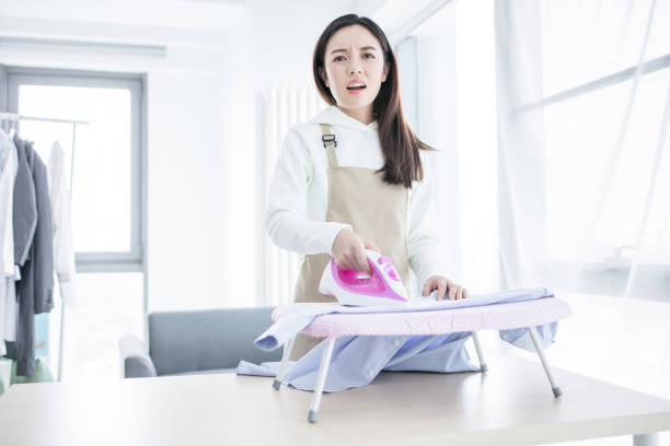 istock Happy young beautiful woman ironing clothes. Housework 2171978577