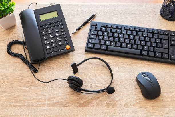 istock An office wooden desk with black telephone, keyboard, mouse and other elements 2171979804
