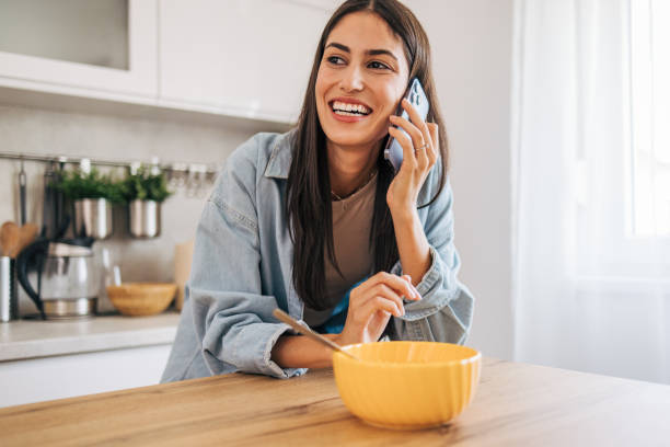 istock A young cheerful woman eating cornflakes for breakfast in the kitchen. 2171982199
