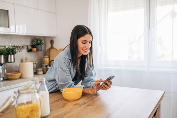 istock A young cheerful woman eating cornflakes for breakfast in the kitchen. 2171983134