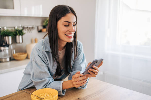 istock A young cheerful woman eating cornflakes for breakfast in the kitchen. 2171983226
