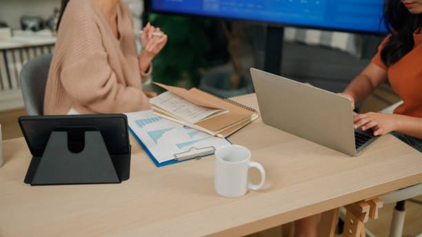istock Young Asian woman explaining data analysis to client who is interested in making business investments. 2171983571