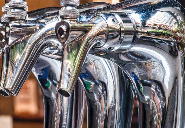 A row of gleaming metal beer taps