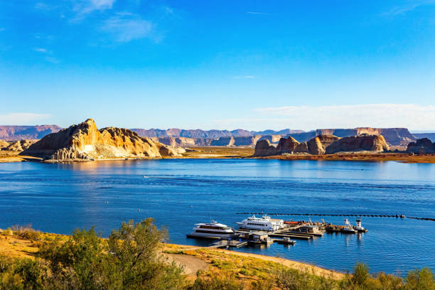 Aerial panorama view of the boats at Lake Powell near the city of Page on the border of Arizona and Utah, southwest USA. The water is a lot lower than it used to be due to climate change and high consumption of water.