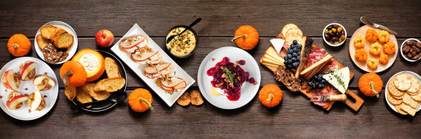 istock Fall theme appetizer table scene against a dark wood banner background 2171988517