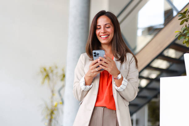 istock Smiling businesswoman using phone in office 2171991865