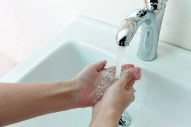 istock Hands being washed under stream of pure water from tap 2171992624