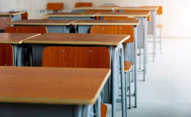istock Empty classroom with chairs and desks in a line 2171992738