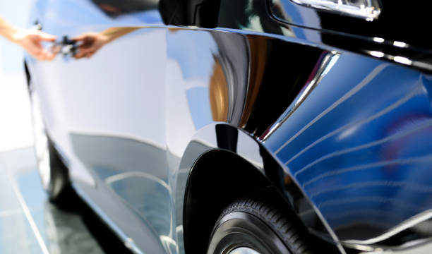 Human hand opening a luxury car door