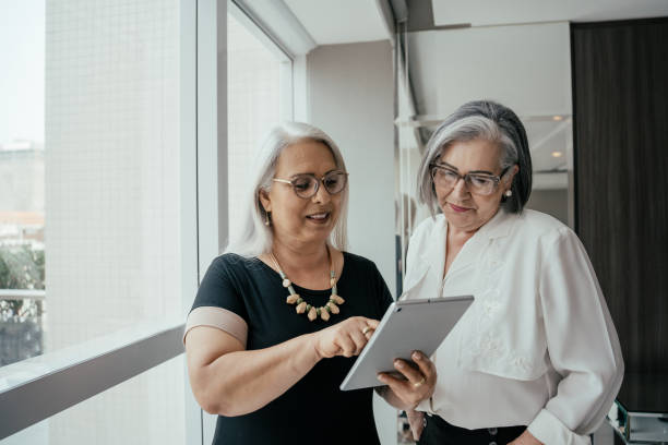 istock Two businesswomen talking about project. 2171995701