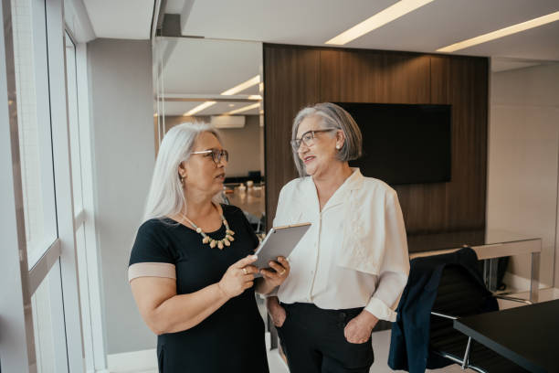 istock Two businesswomen talking about project. 2171995702
