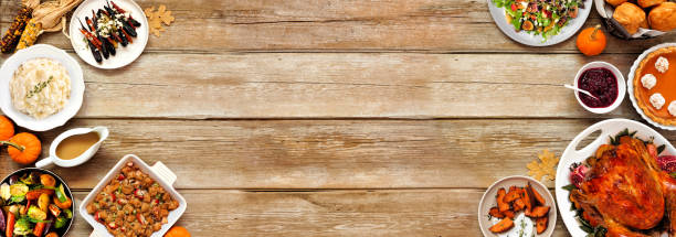 istock Thanksgiving turkey dinner. Top down view double border on a rustic wood table banner background. 2171995726