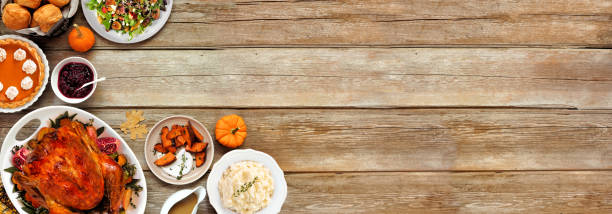 istock Thanksgiving turkey dinner. Top view corner border on a rustic wood table banner background. 2171995731