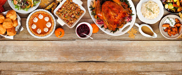 istock Thanksgiving turkey dinner. Overhead view top border on a rustic wood table banner background. 2171995735