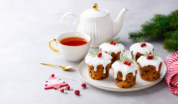 istock Christmas puddings, cakes with tea. Traditional dessert. Grey background. Copy space. 2171997342