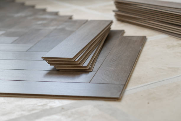 Laminate floor installation in a modern apartment, showing tools, planks