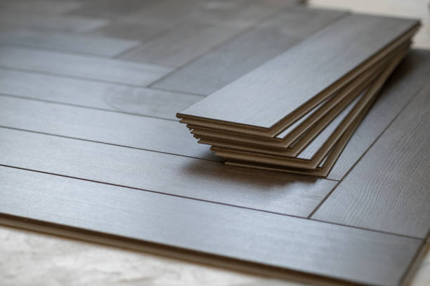 istock Professional laminate flooring installation in a bright apartment interior. 2171998430