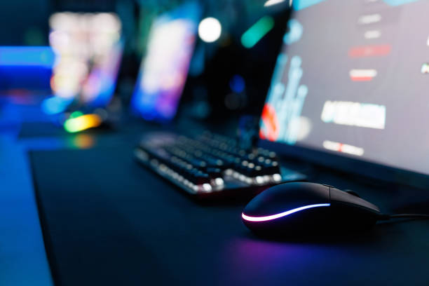 istock Futuristic gaming mouse with rgb lighting in a neon-lit gaming setup. 2172003342