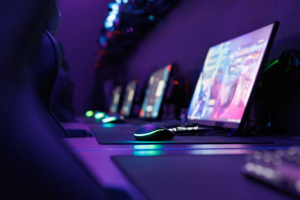 istock Professional gaming table with gaming PC, headset, keyboard, mouse and monitor with neon light. 2172003588