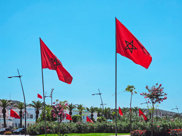 istock low angle view of Moroccan flags against blue sky in Fnideq, Morocco 2172006075