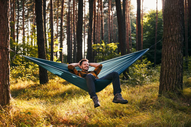 istock Mid adult man relaxing on hammock in the forest 2172008846